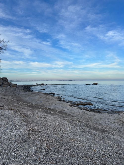 Free Calm and serene beach at Lake Erie, Ontario, with tranquil water and blue sky. Stock Photo