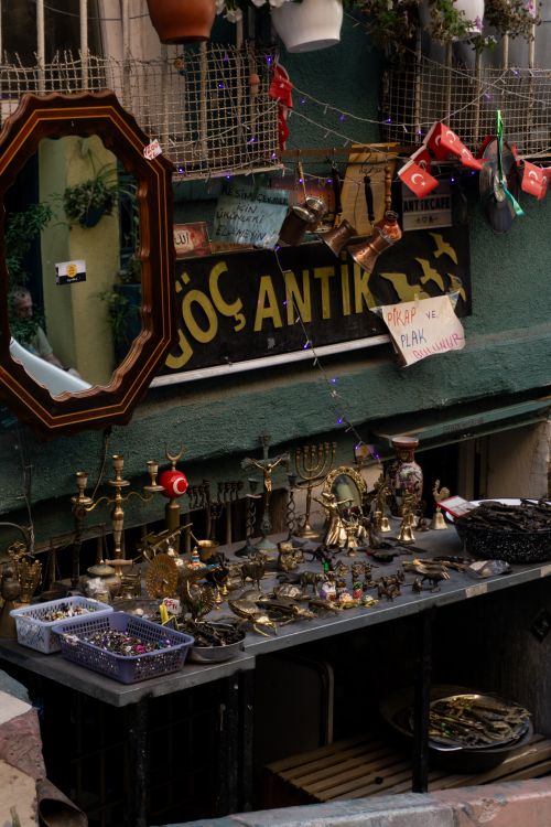 Free Charming antique shop display in Istanbul with vintage decor and Turkish flags, showcasing a rich cultural heritage. Stock Photo