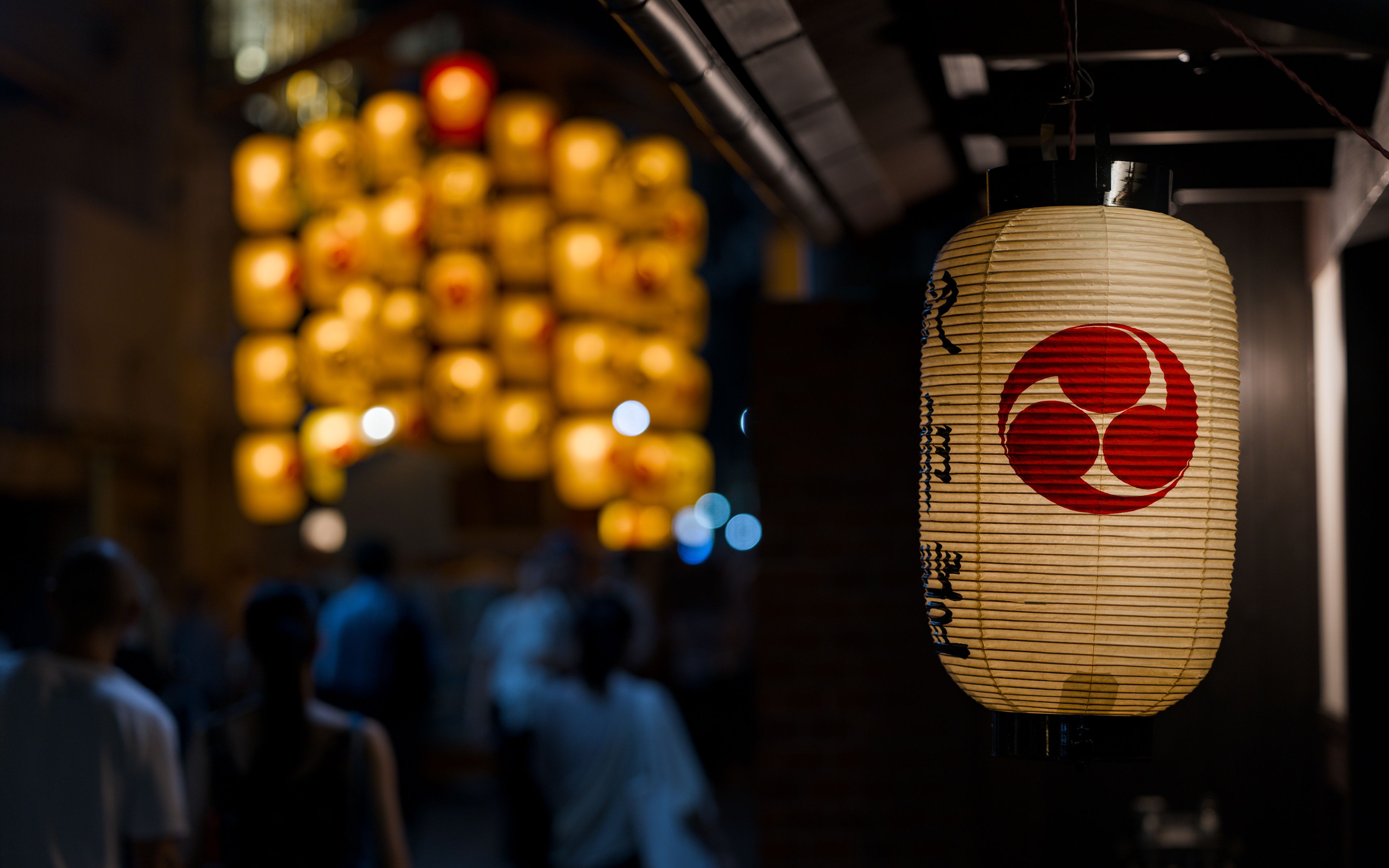 paper lanterns glowing at night during Gion Matsuri in Kyoto