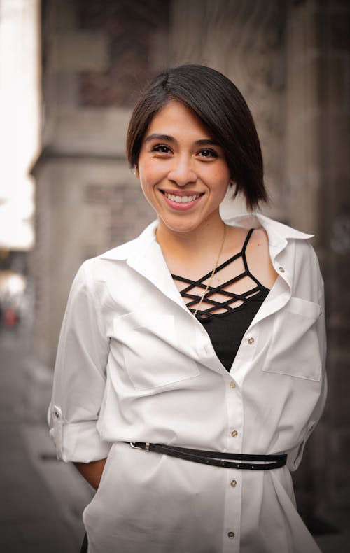 A Woman in White Top Smiling