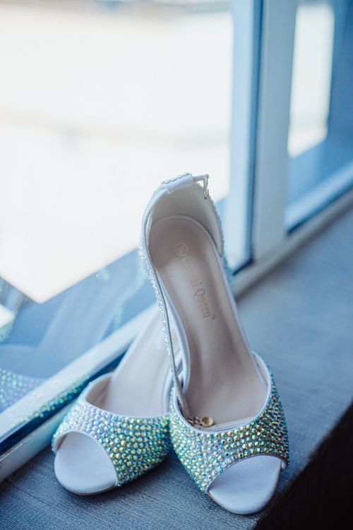 Free Stylish rhinestone high heels by a window, perfect for bridal wear or formal events. Stock Photo