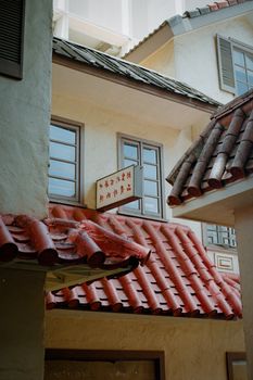 Charming traditional Asian building with distinct red roof tiles and decorative windows.