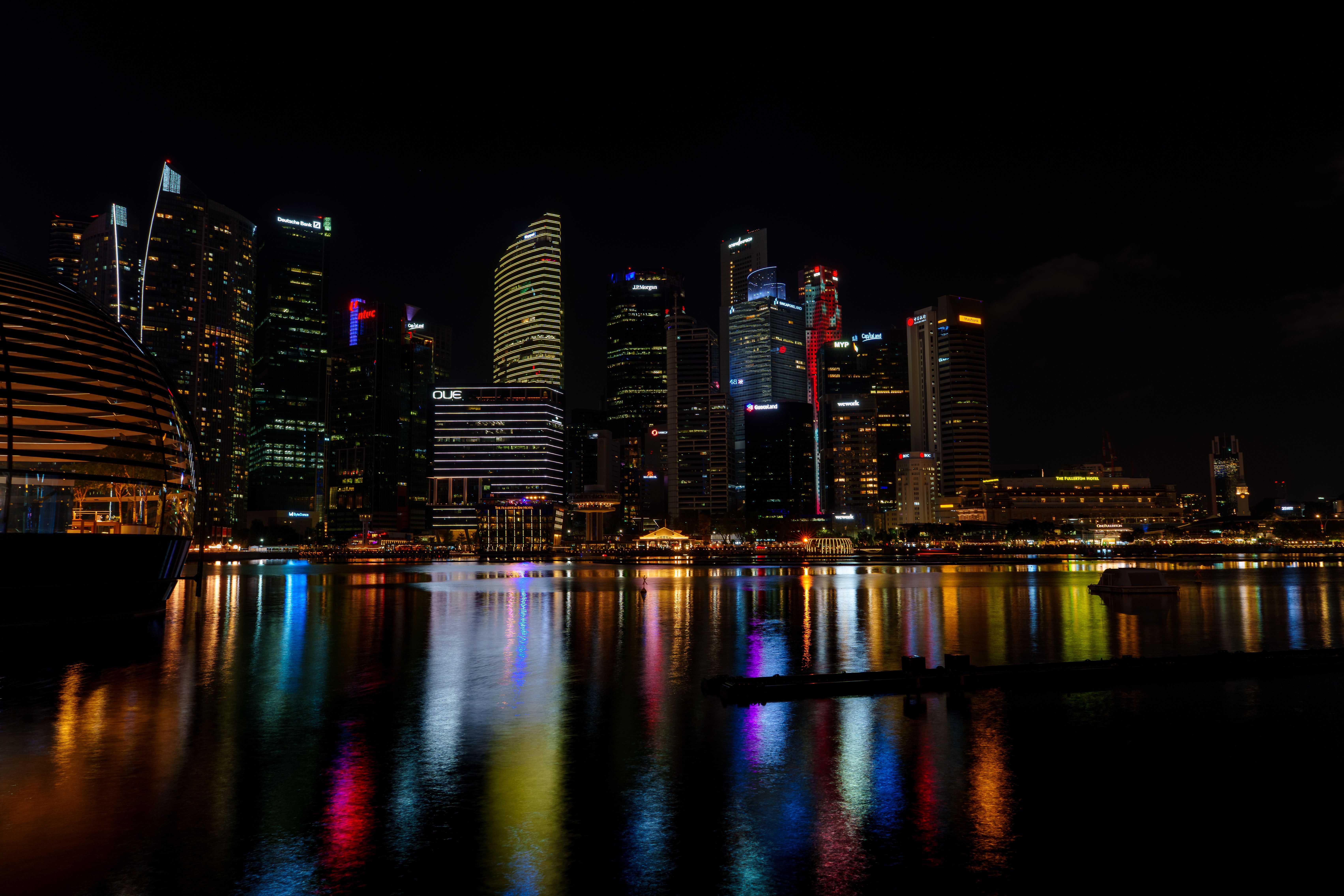 Night view of Singapore's illuminated skyline and Marina Bay Sands, reflecting vibrant city lights. — photo by Richard L / Pexels