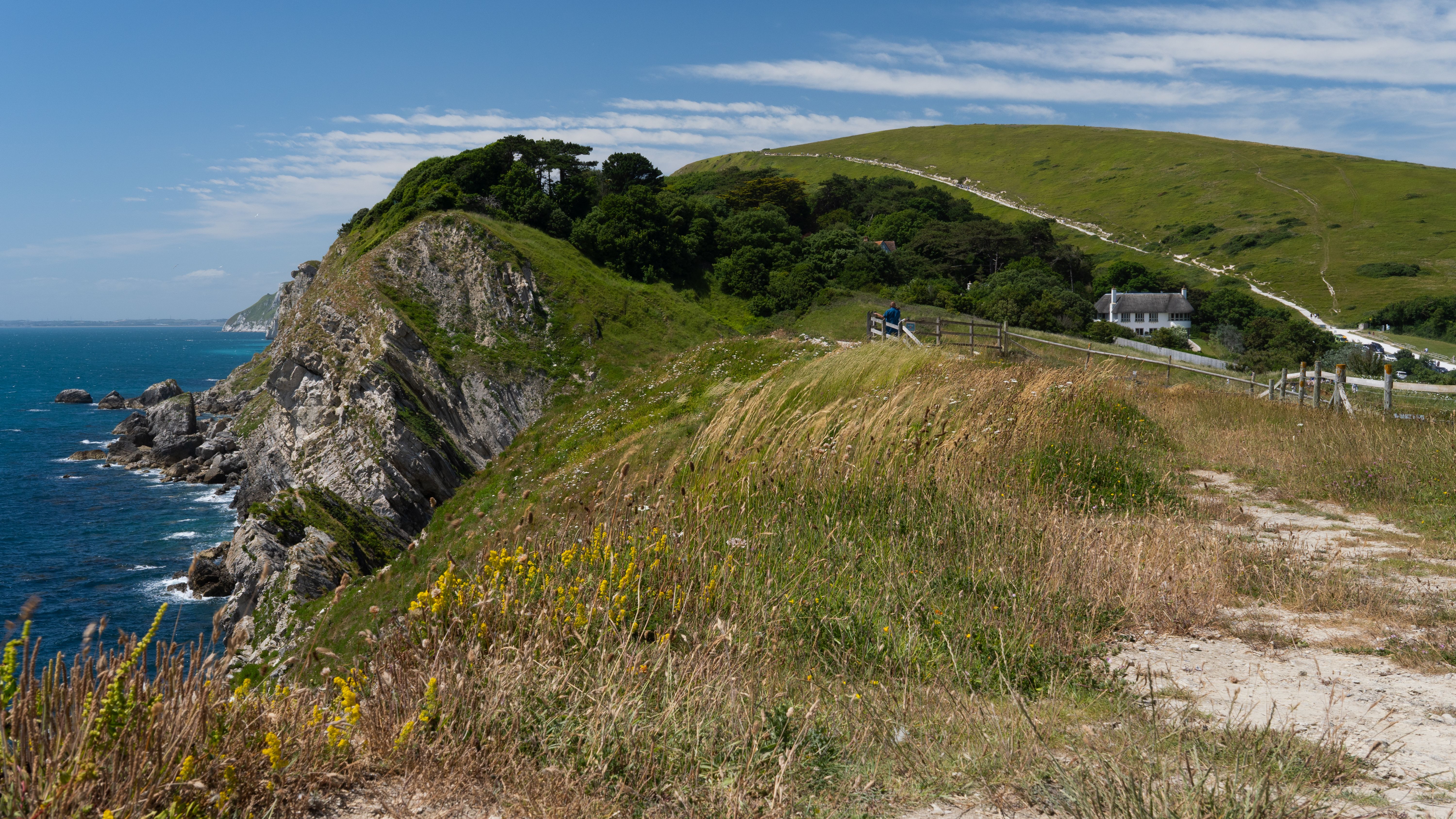 A grassy cliff path above the Dorset coast, the off-season weekend FatFace has been selling for decades.