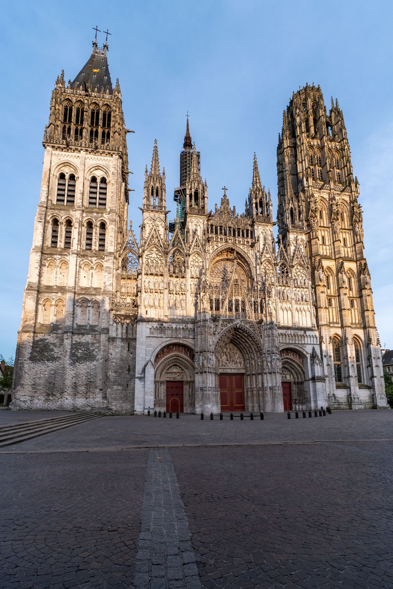Rouen Cathedral's Gothic façade illuminated by morning sunlight at dawn, France