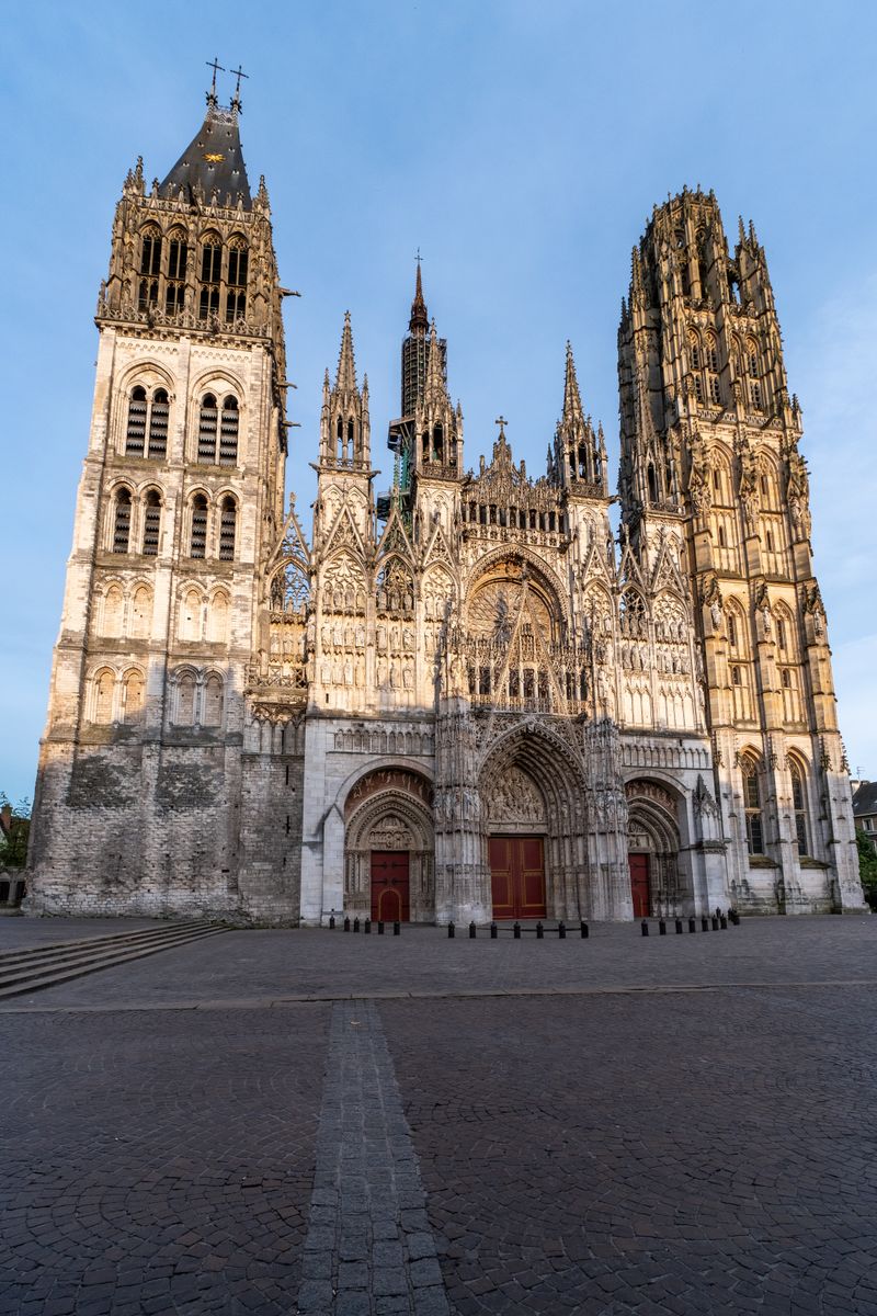 Rouen Cathedral at dawn — Gothic façade illuminated by morning sunlight