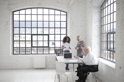Free Group Of People Preparing For A Meeting Stock Photo