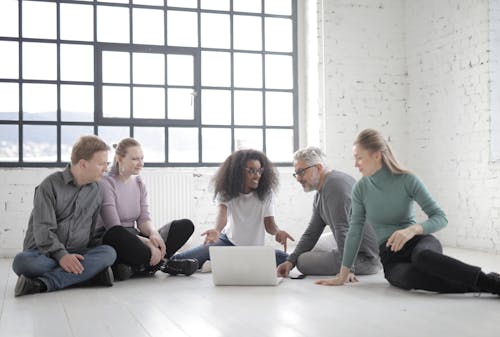 Group Of People Having A Discussion While Seated On The Floor