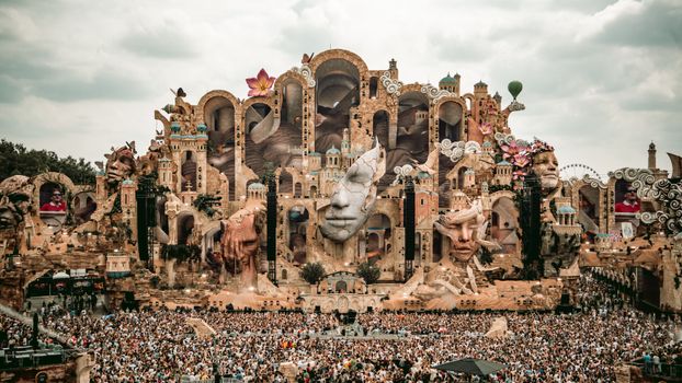A breathtaking view of the Tomorrowland festival stage in Boom, Belgium, filled with vibrant decorations and a massive crowd.