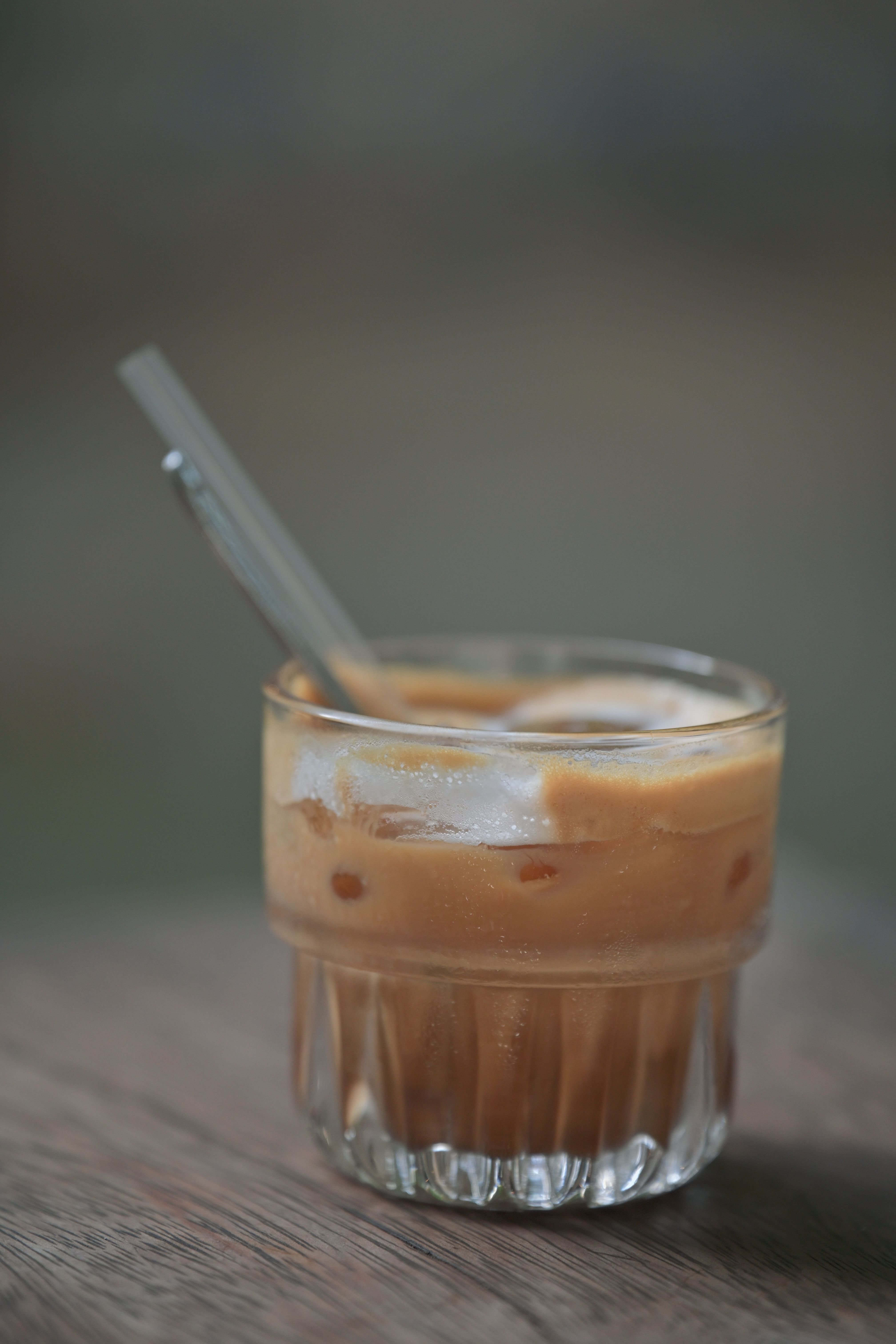 Refreshing iced coffee served in a glass with a straw, perfect for a summer day.