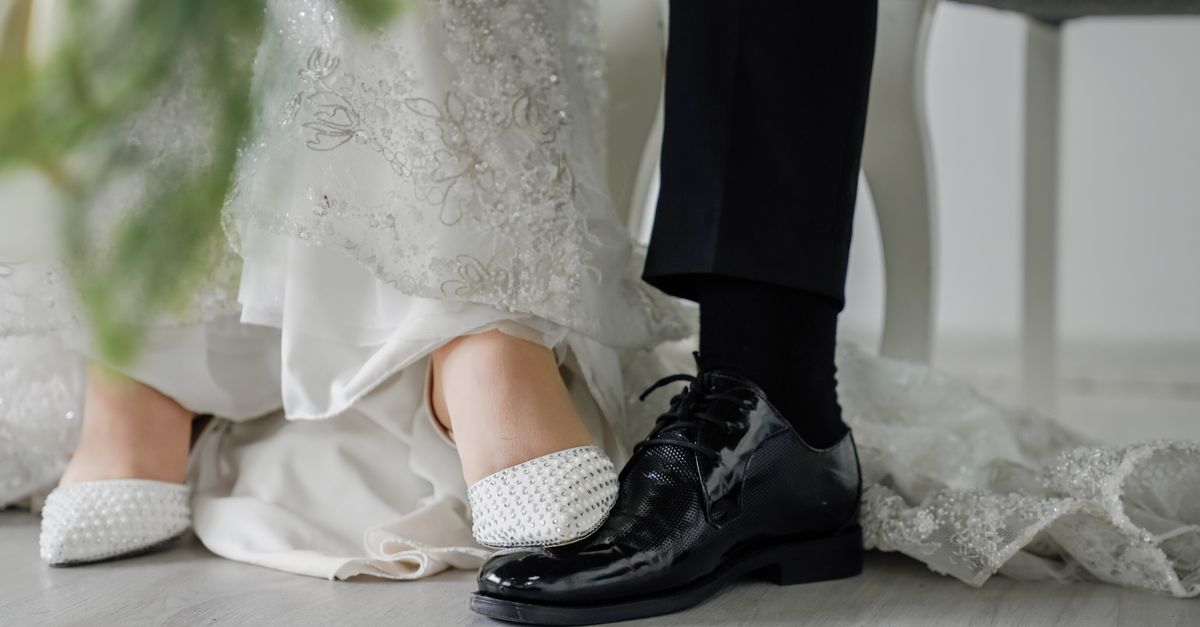 Close-up of elegant wedding shoes and attire, highlighting details and craftsmanship.