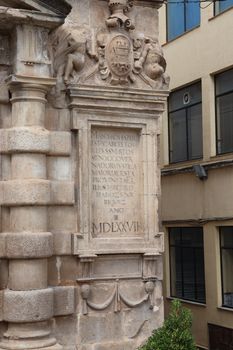 Close-up of a historical plaque on a building facade in Martos, Andalucía, Spain.