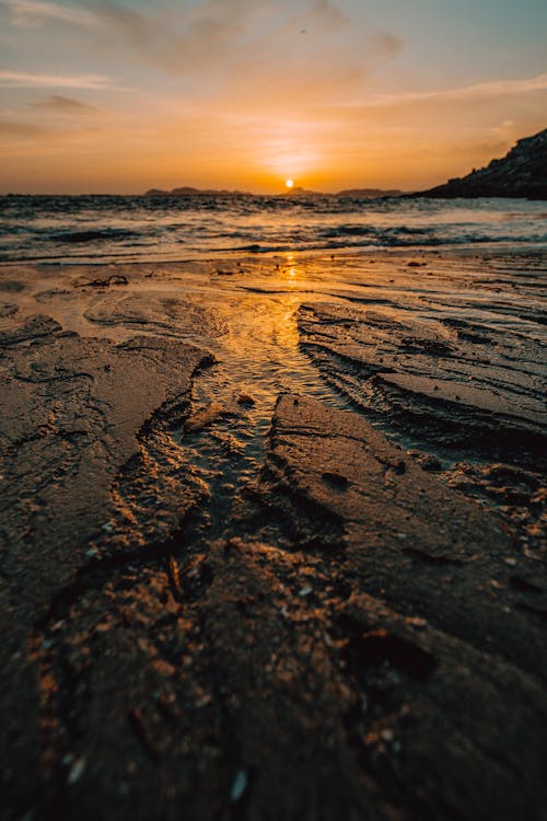 Free Sea Waves Crashing On Shore During Sunset Stock Photo