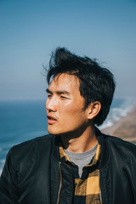 Casual portrait of a man enjoying a sunny day by the ocean
