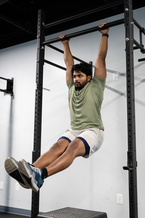 Free Adult male working out by doing pull-ups to build strength and fitness. Stock Photo