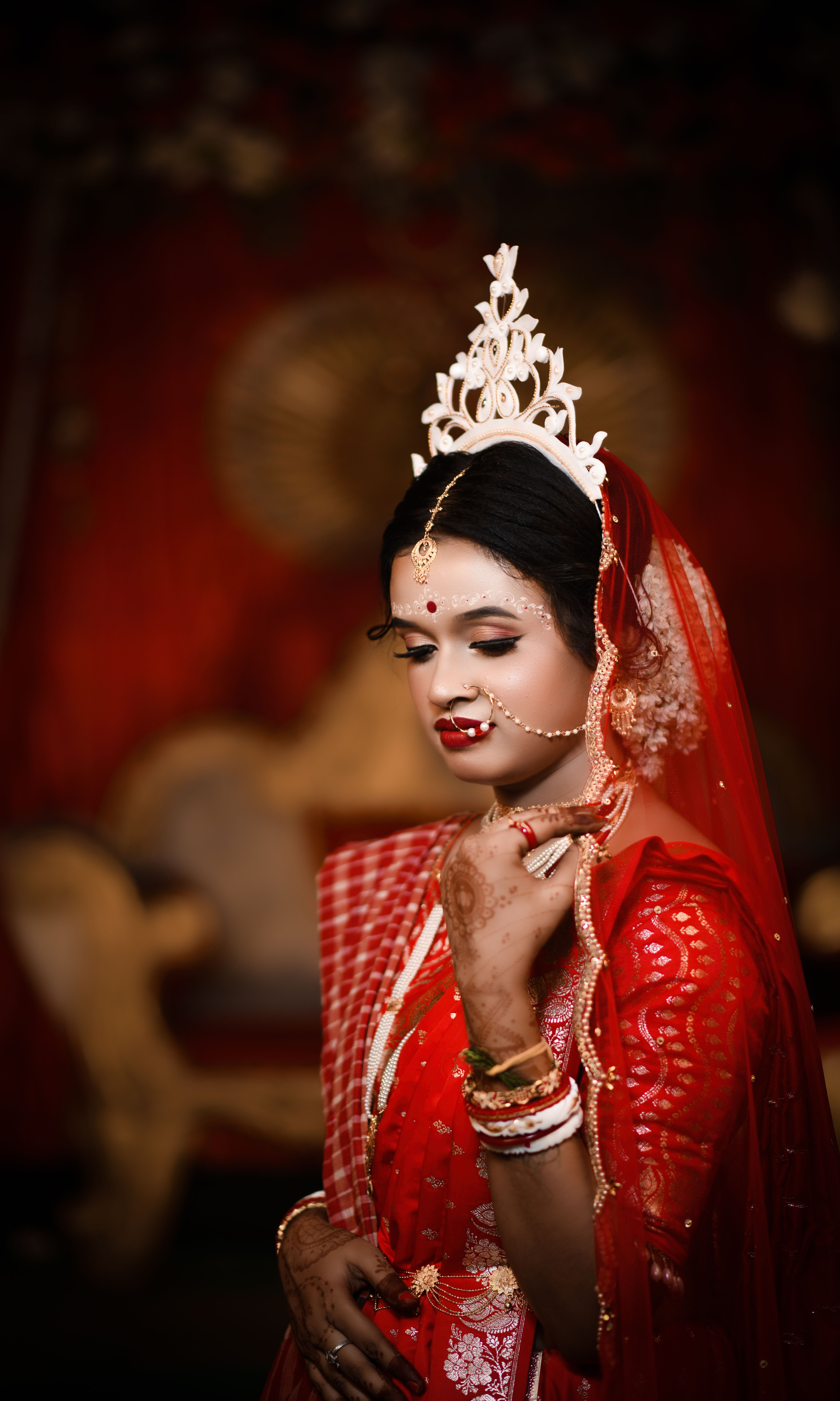 Portrait of a beautiful bride in traditional Bengali attire, showcasing cultural elegance.