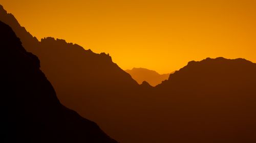 Free Captivating view of the Écrins mountains at sunrise, showcasing warm hues and layered peaks. Stock Photo