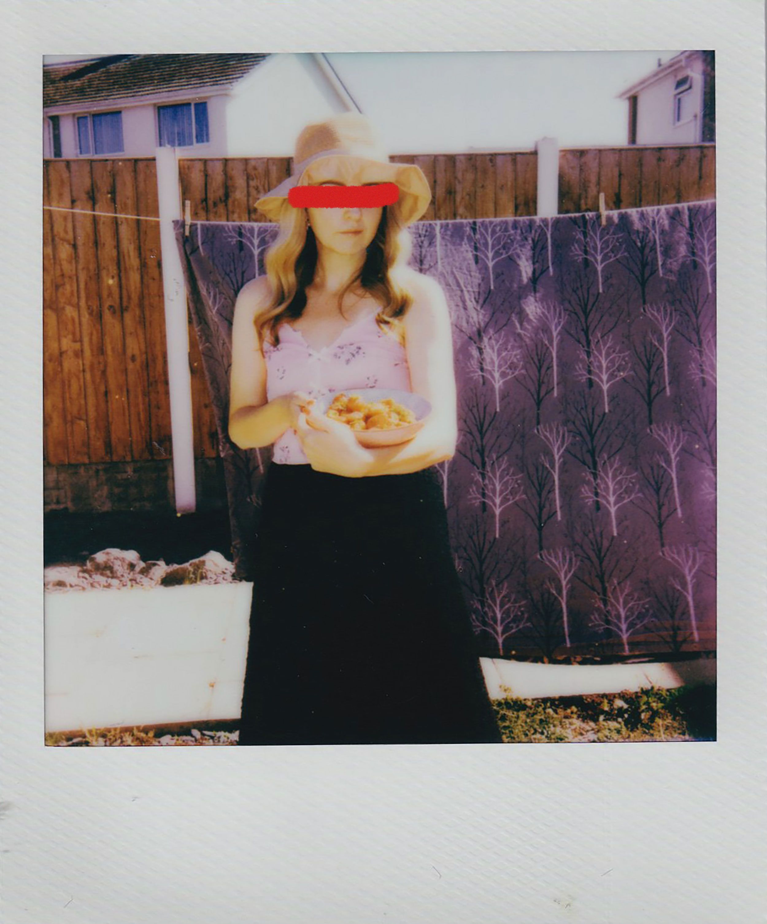 Woman in hat holding bowl of fruits outdoors. Summer feel.