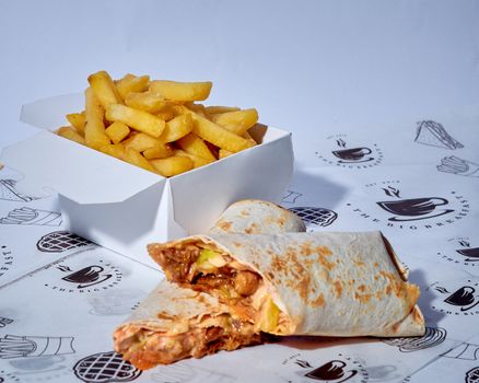Tasty burrito with fries on branded paper, perfect for fast food promotions.