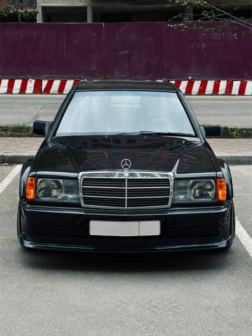 Free Front view of classic black sedan parked in an urban setting. Stock Photo