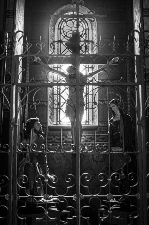 Free Black and white image showcasing religious sculptures inside a church, with dramatic backlighting. Stock Photo