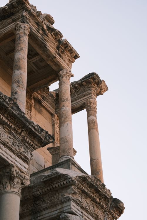 Free Detailed view of ancient Roman columns against a clear sky, showcasing classical architecture. Stock Photo