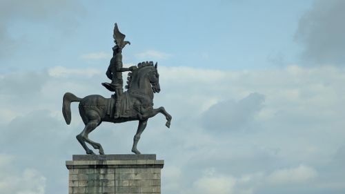 Free A striking equestrian statue silhouetted against a cloudy sky in Poti, Georgia. Stock Photo
