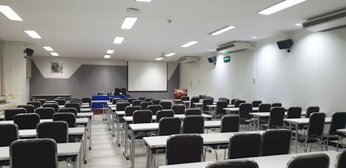 Free An Empty Tables and Chairs Inside the Classroom Stock Photo