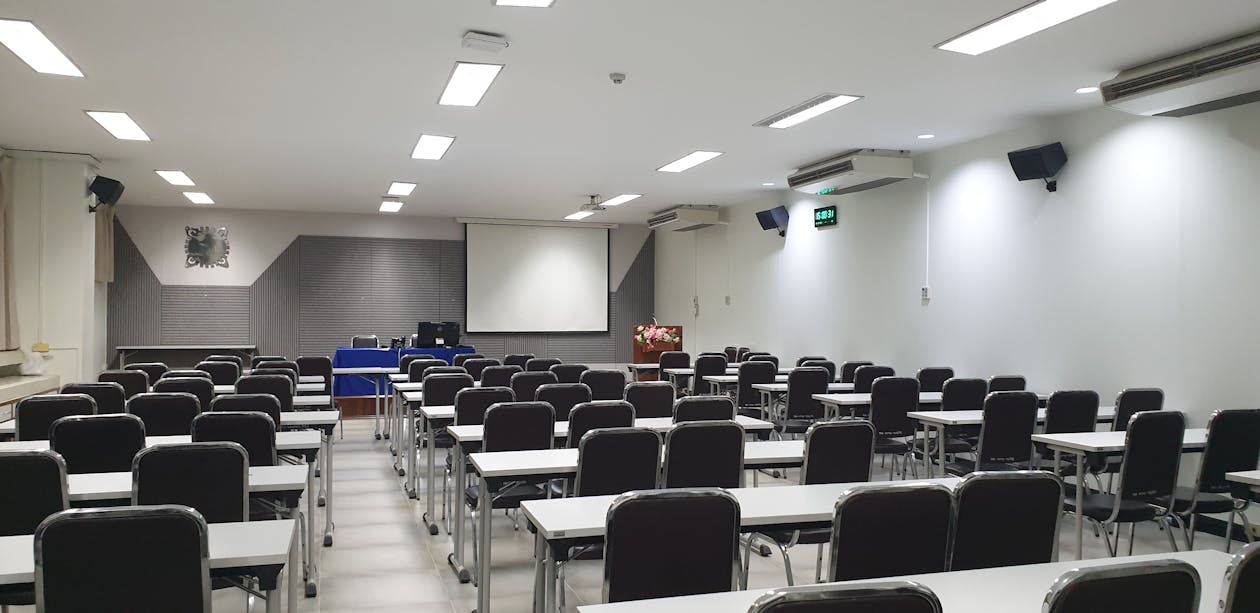 Free An Empty Tables and Chairs Inside the Classroom Stock Photo