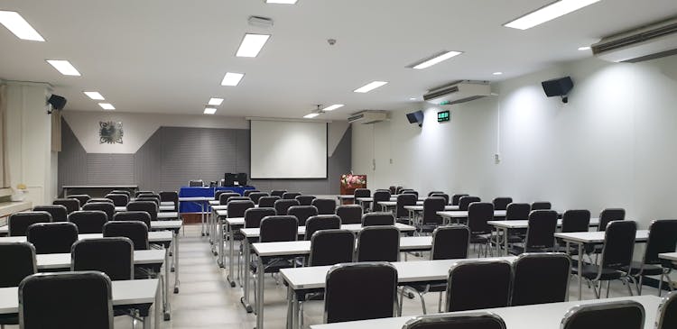 An Empty Tables And Chairs Inside The Classroom