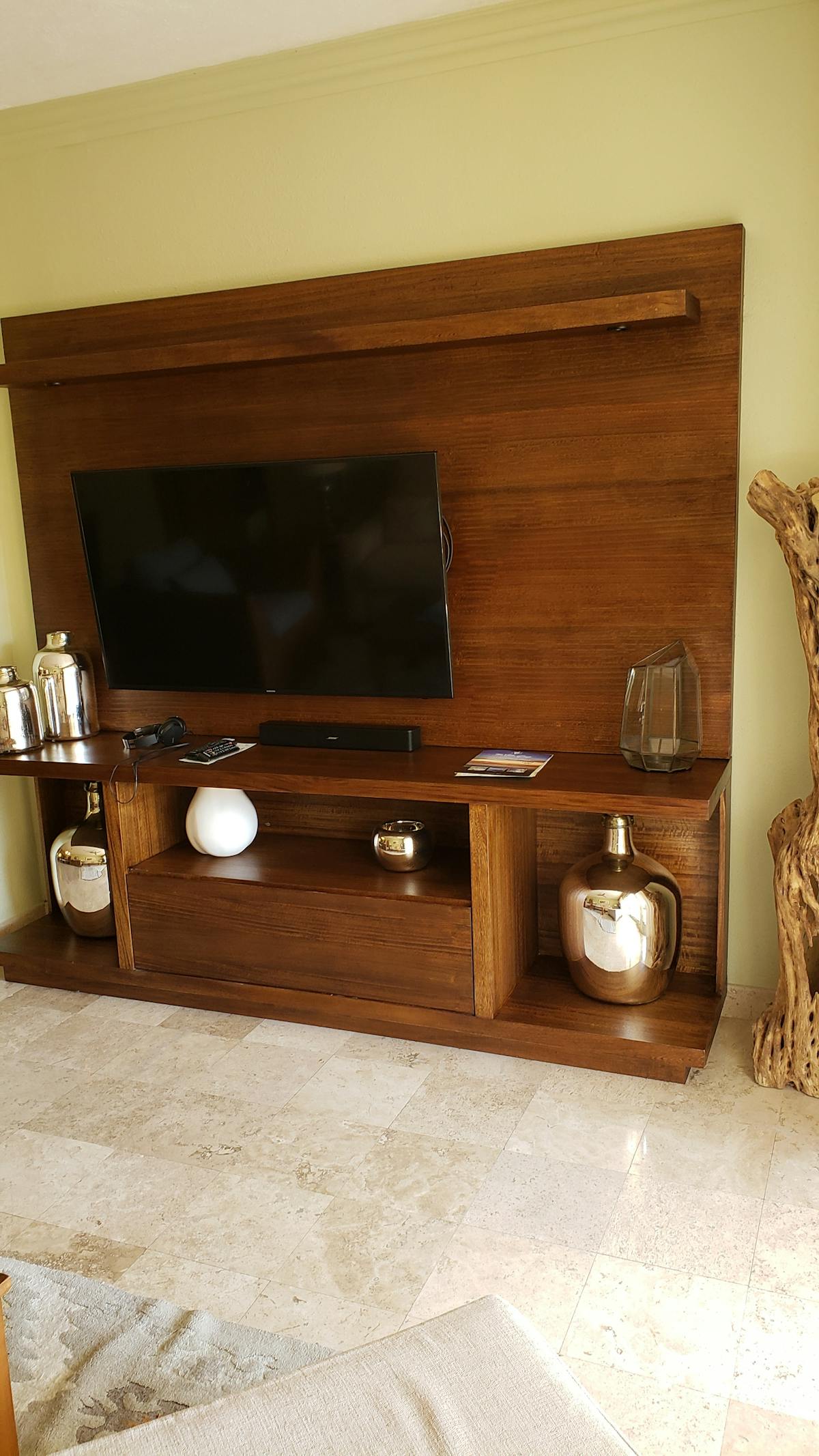 Close-up of a person drizzling sauce over a grain and vegetable bowl