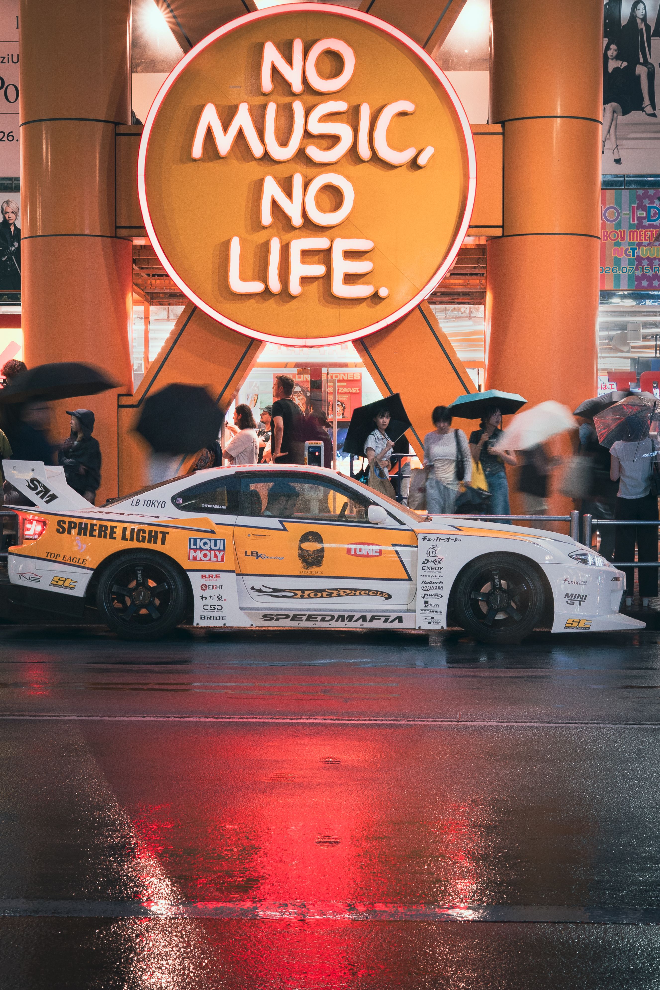 Dynamic Tokyo street scene with sports car and 'No Music, No Life' neon sign.
