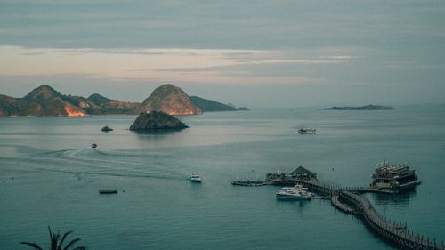 Free Calm morning view of Labuan Bajo harbor with boats and scenic islands in the distance. Stock Photo