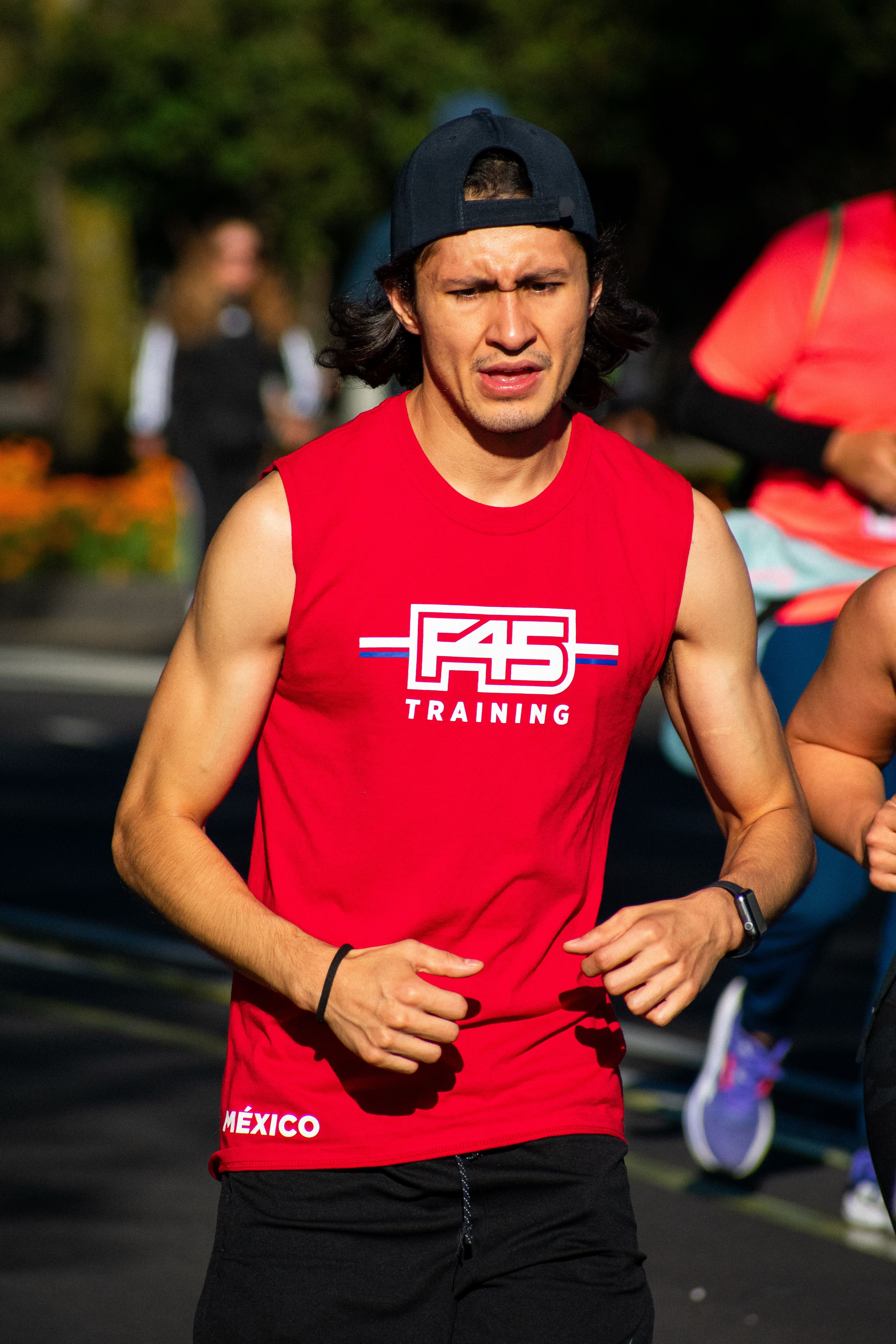 Focused male athlete running in Ciudad de México during a marathon event.