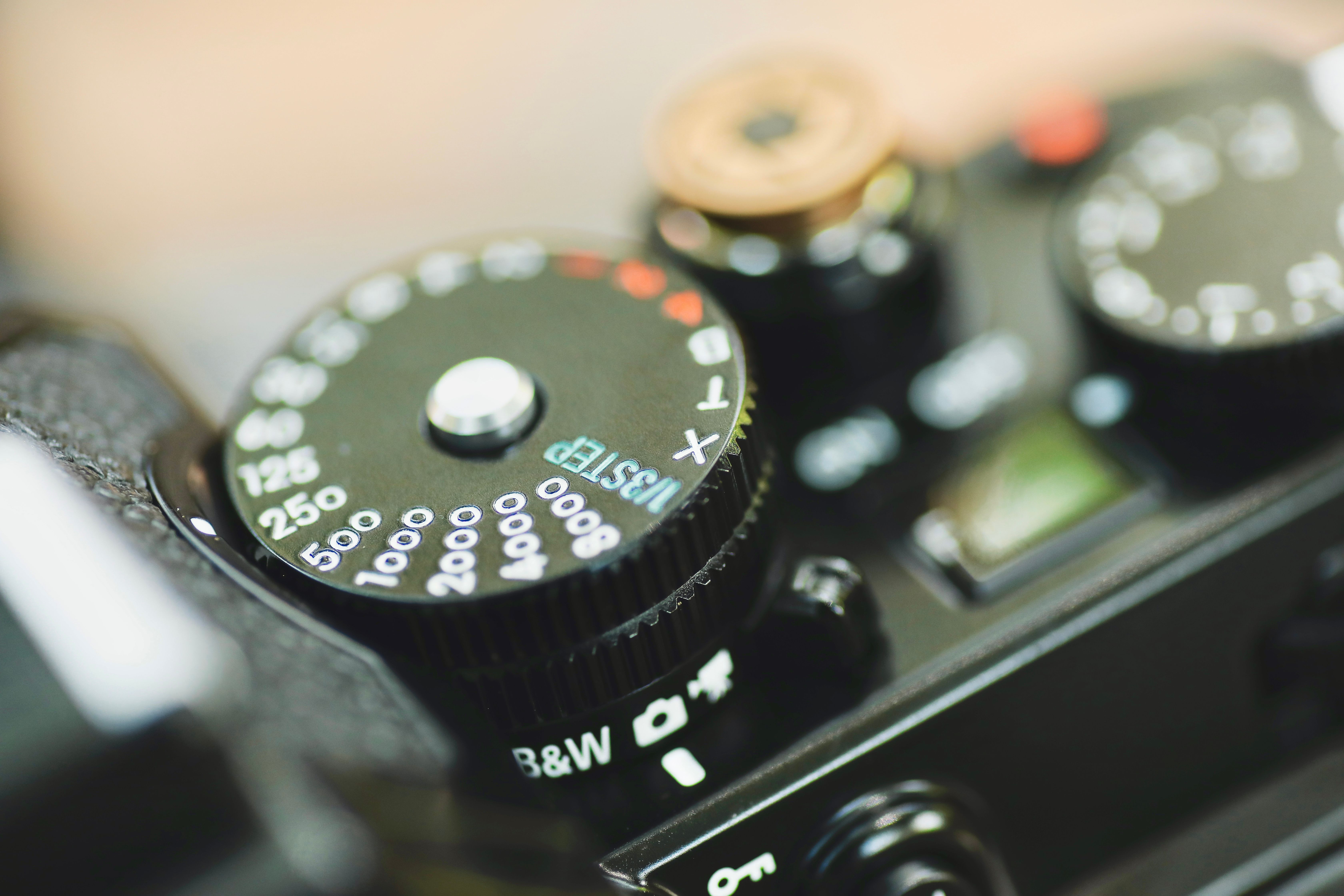 Detailed view of a vintage camera's exposure settings dials, highlighting texture and design.