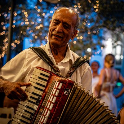 Accordion player at an outdoor evening set - photo by Hakan Sapci on Pexels