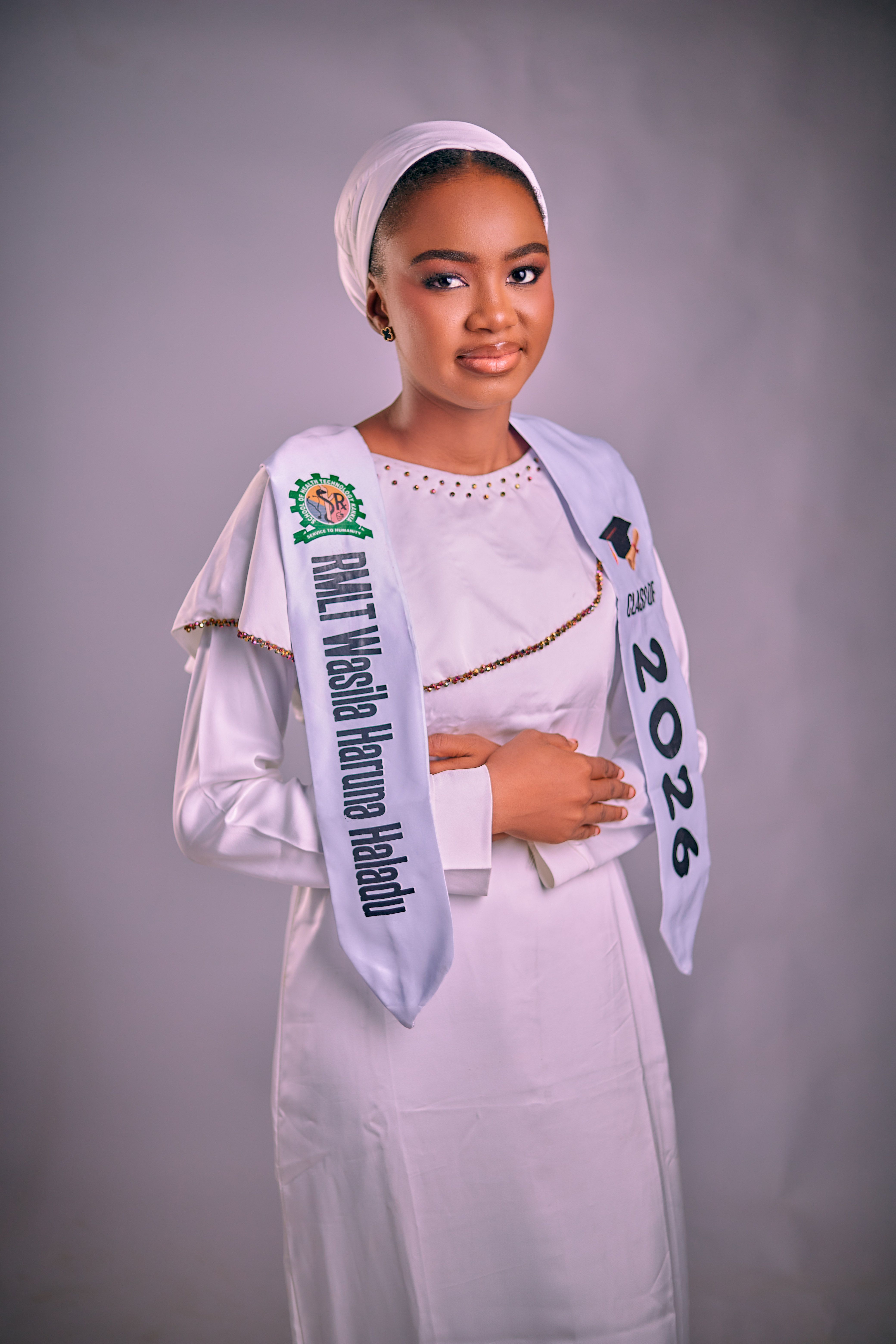 Portrait of a young woman wearing graduation attire, representing academic achievement.