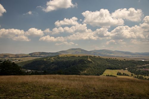 Free Breathtaking landscape of Zlatibor hills under a sky filled with fluffy clouds in Serbia. Stock Photo