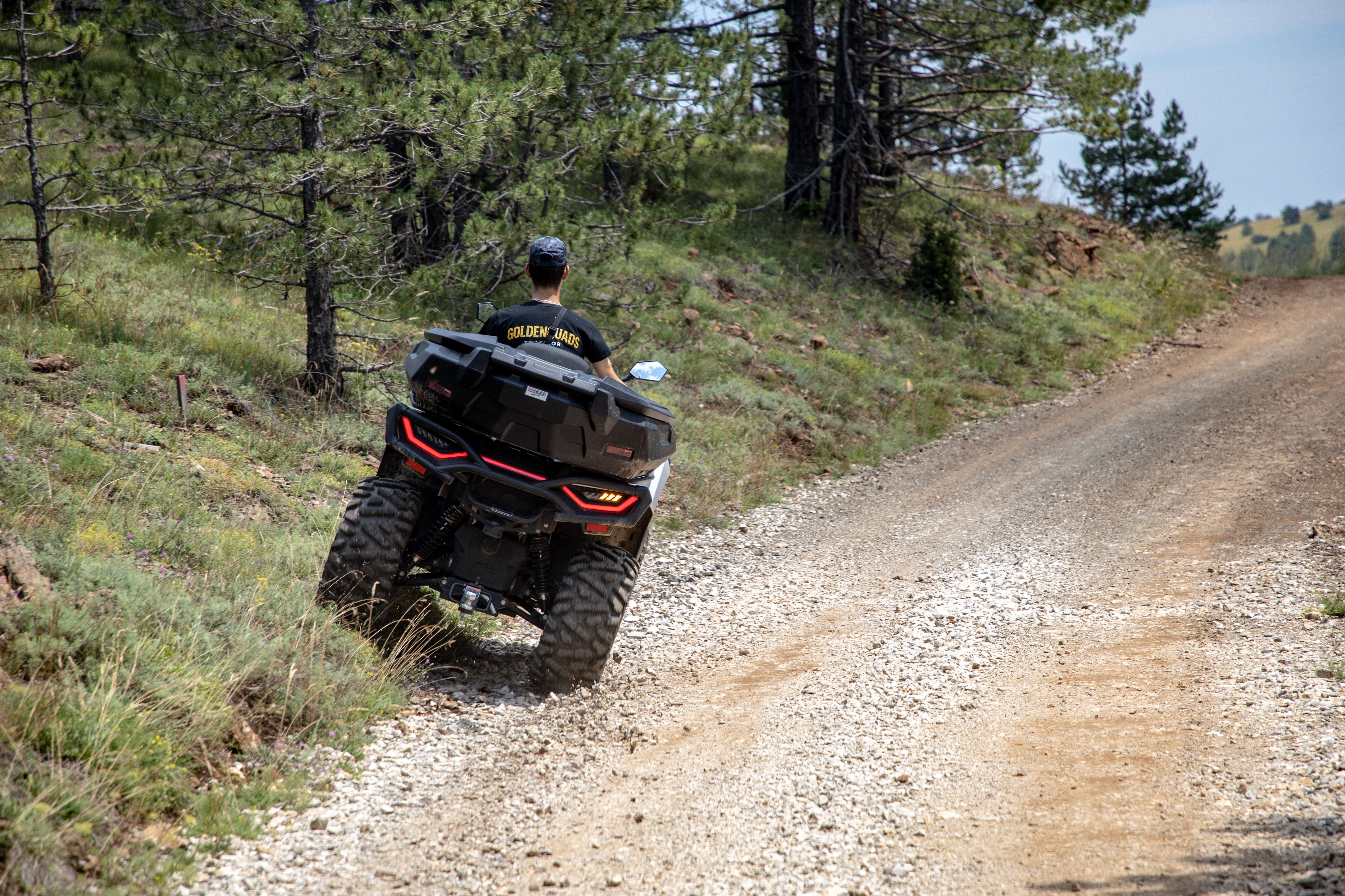 A person rides an ATV on a rugged mountain path in Zlatibor, Serbia, showcasing outdoor adventure.