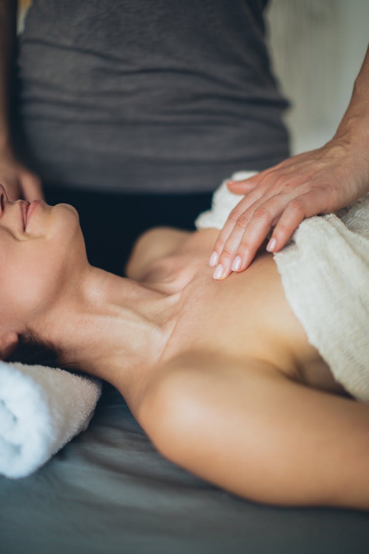 A Person Touching A Woman's Chest