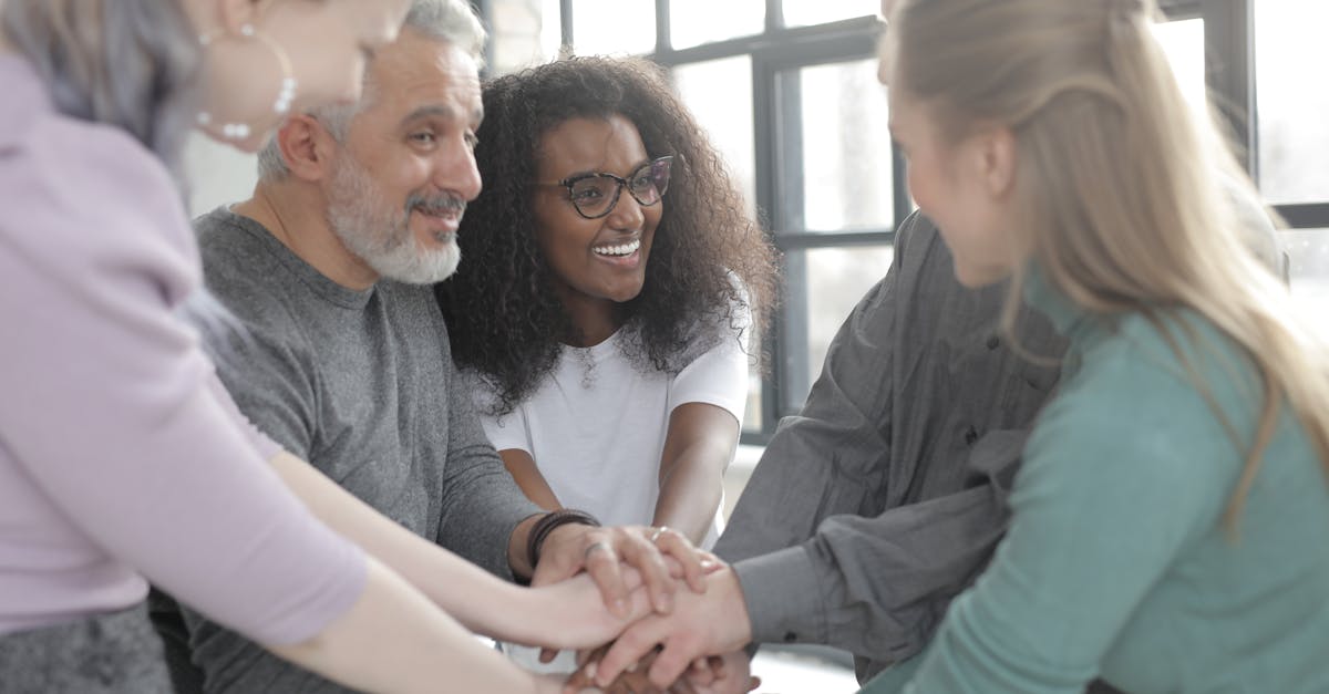 Group Of Colleagues Inviting A Quiet Coworker To Join Them For Lunch Or A Walk In An Office Or Outdoor Setting