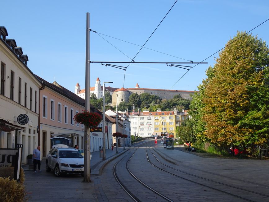 A tram in Košice, Slovakia, passing by historical architecture.