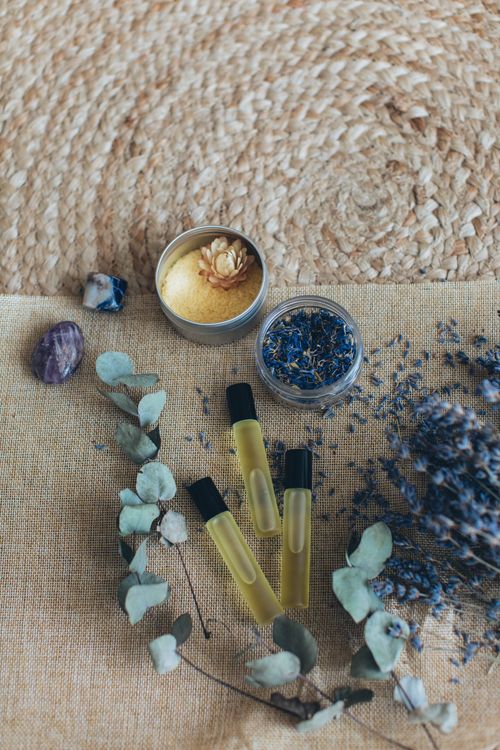 Free Top view of aromatherapy set with lavender, essential oils, and crystals on woven mat. Stock Photo