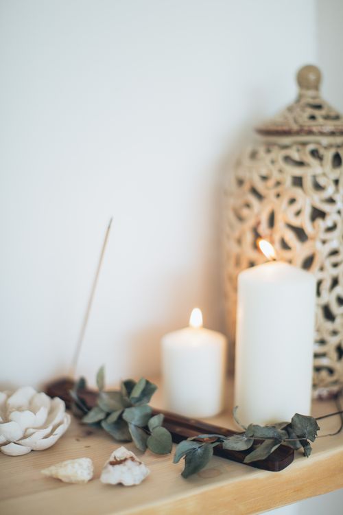 Free Calming still life featuring lit candles, eucalyptus, and shells for relaxation ambiance. Stock Photo