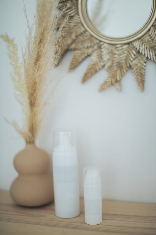 White Pump Bottles on Wooden Surface