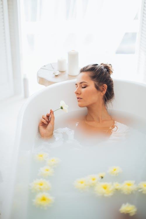 A Beautiful Woman in a Bathtub with Flowers