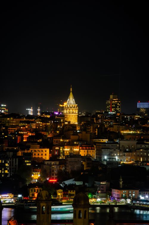 Free Night view of Istanbul skyline with the illuminated Galata Tower amidst city lights. Stock Photo