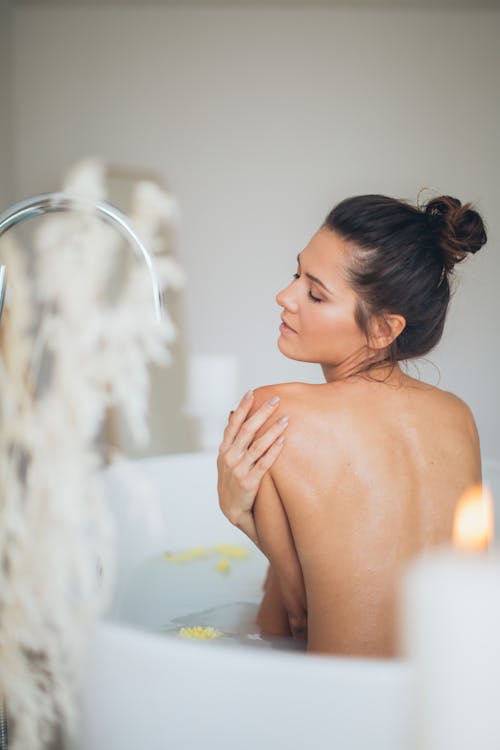 Free Topless Woman in Bathtub With Water Stock Photo