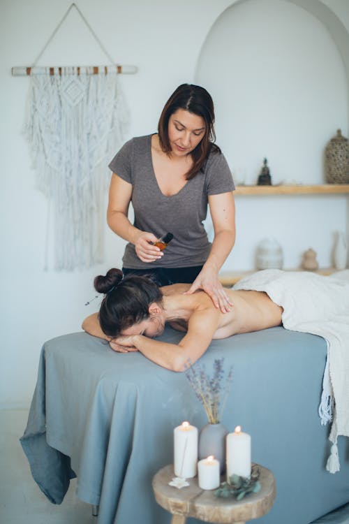 Free A Shirtless Woman Having a Massage Stock Photo