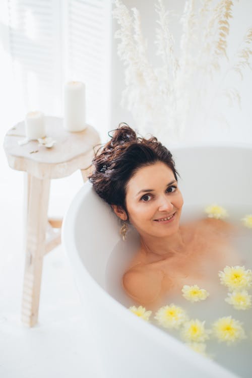 Woman Lying in Bathtub With Water